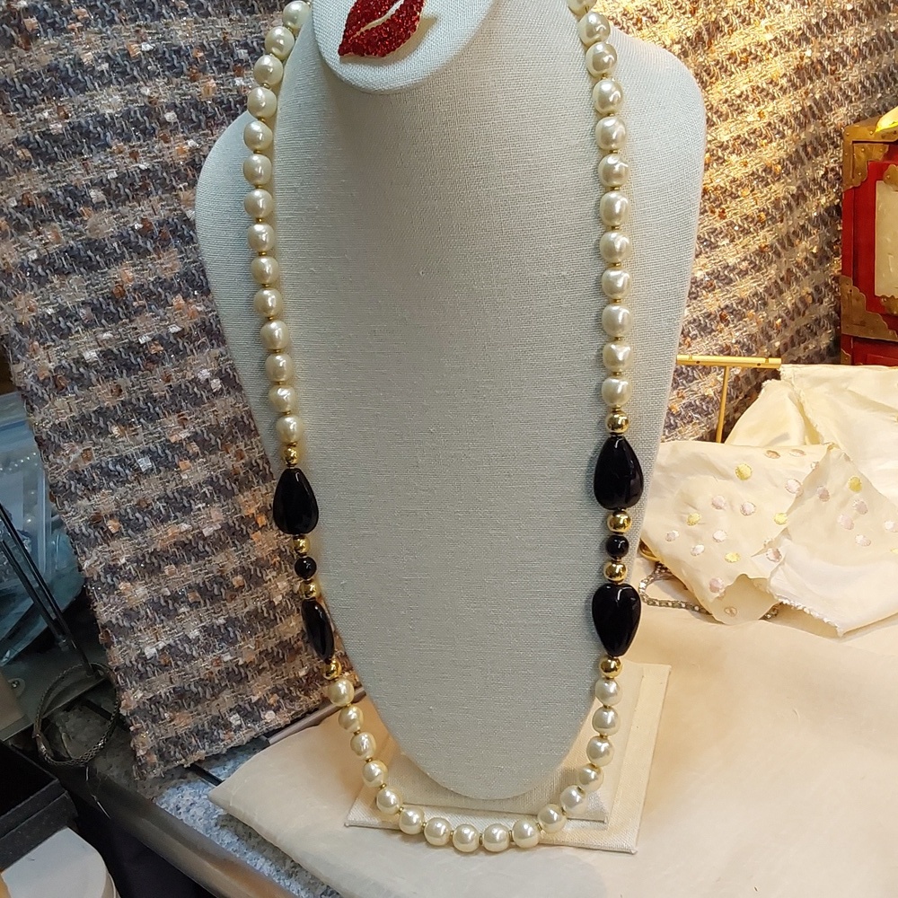 White faux pearl with black blue luciete. 32 in long